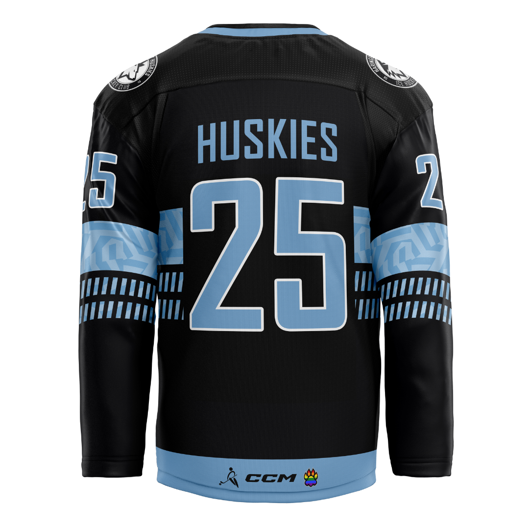 The Haringey Huskies 25/26 Away Jersey (NO NAME) from the Haringey Huskies Store is black with blue and white accents, features HUSKIES and the number 25 on the back, and has light blue geometric patterns—ideal for fans.