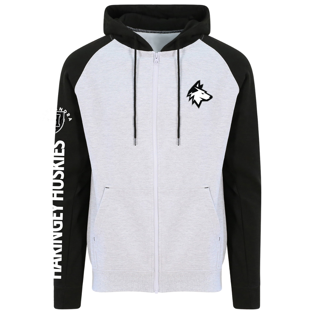 The Huskies Zip Hoodie Black/Grey from Haringey Huskies Store features black sleeves, a light gray body, a stylized husky head on the chest, HANINGE HUSKIES on the left sleeve, and is lined with soft fleece for added warmth.