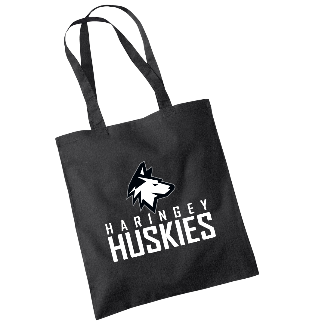 Show your team spirit with the Huskies Tote Bag Black Logo from Haringey Huskies Store—a durable black tote with two handles, featuring a bold husky head logo over Haringey Huskies lettering.