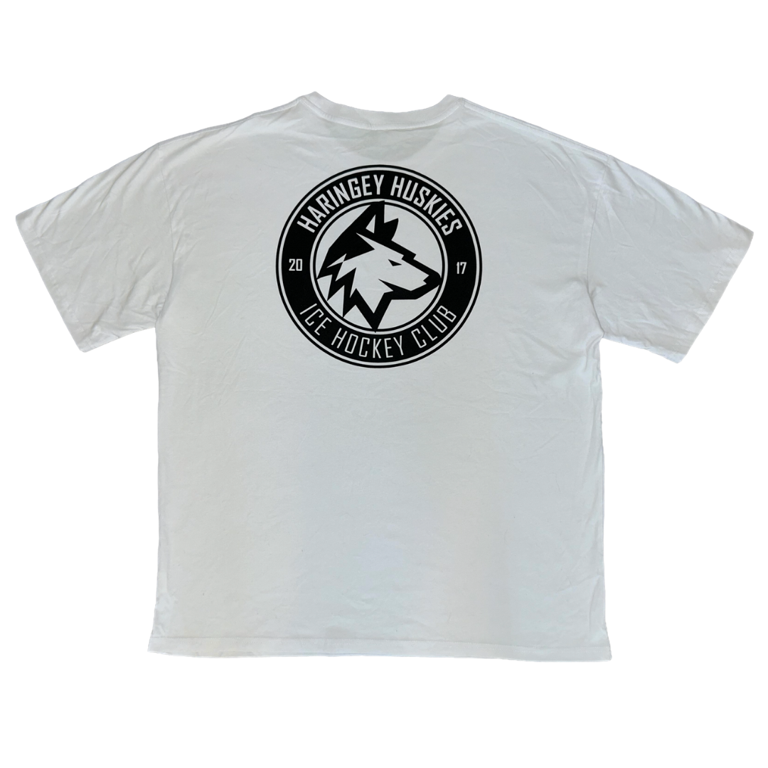The Huskies Oversized T-Shirt White from the Haringey Huskies Store features a bold black and white circular logo on the back with “Haringey Huskies Ice Hockey Club 2017” written around a stylized husky head at the center.