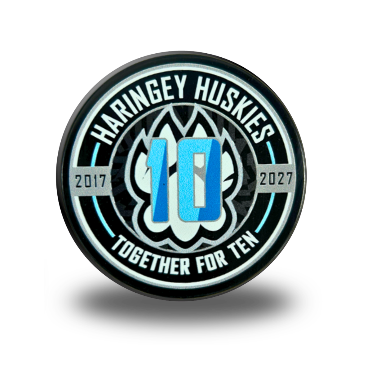 The Huskies 10 Years Puck from Haringey Huskies Store features the text “Haringey Huskies,” “2017,” “2027,” “10,” and “Together For Ten,” along with a stylized husky logo in the background.